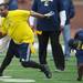 DiAllo Johnson runs the ball around Chris Floyd during the Victors Classic alumni football game at Michigan Stadium on Saturday. Melanie Maxwell I AnnArbor.com
